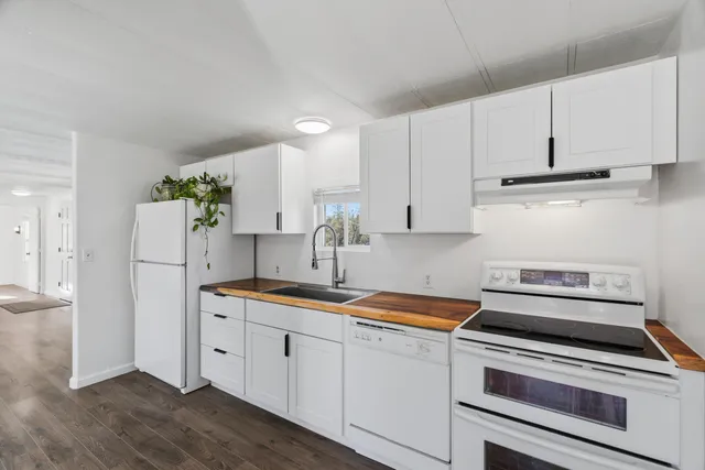 a kitchen with appliances a sink and cabinets