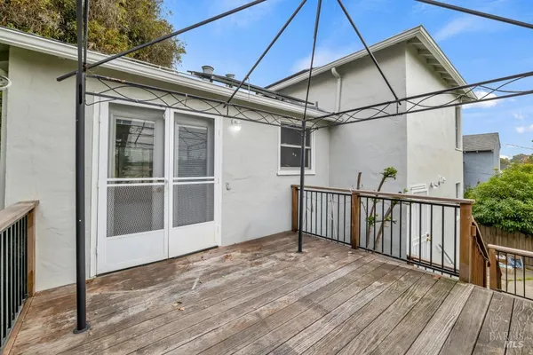 a view of a house with backyard and deck