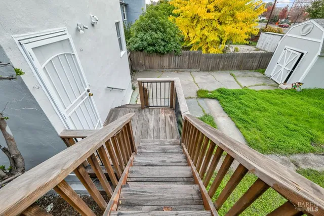 a view of a house with a yard and pathway