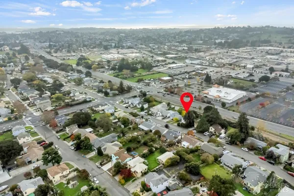 a aerial view of a house with a yard and large tree
