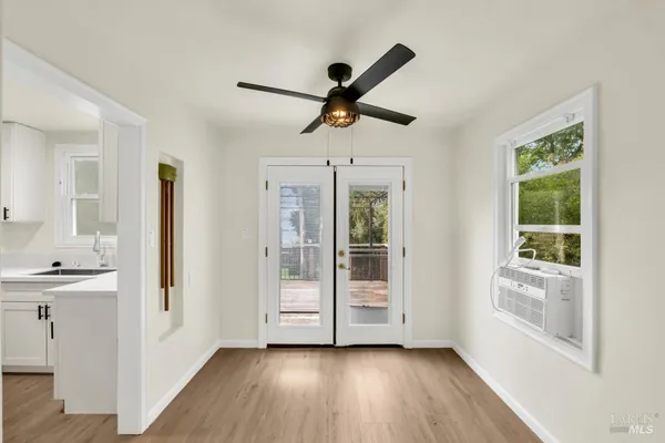 a view of a room with wooden floor and windows