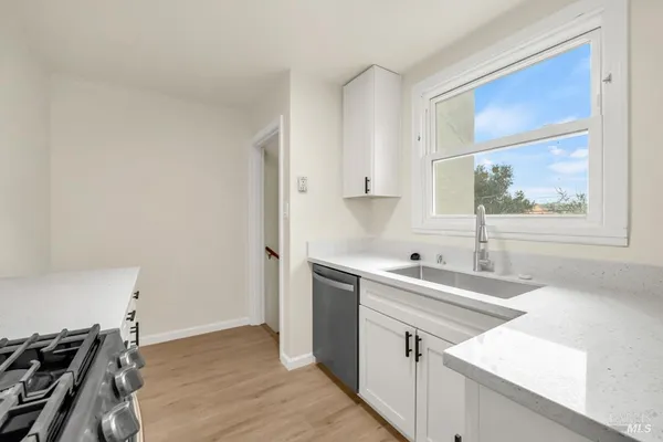 a kitchen with a sink stove and cabinets