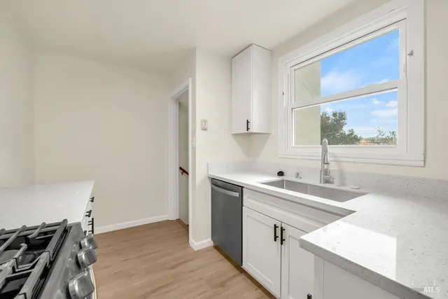 a kitchen with a sink stove and cabinets
