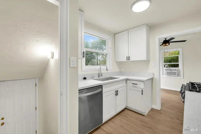 a kitchen with a sink cabinets and window