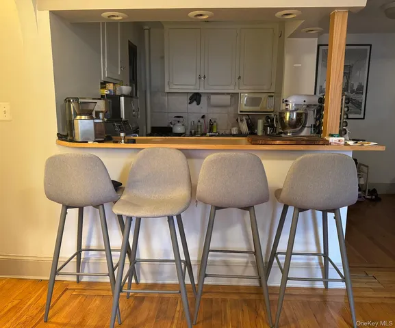 a kitchen with a table chairs sink and cabinets
