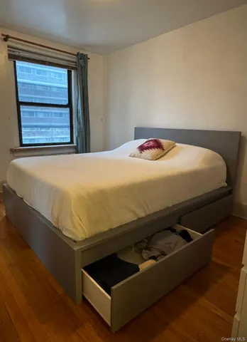 a bed sitting in a bedroom next to a window