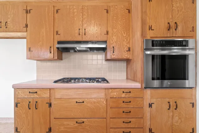 a kitchen with granite countertop a stove and a microwave