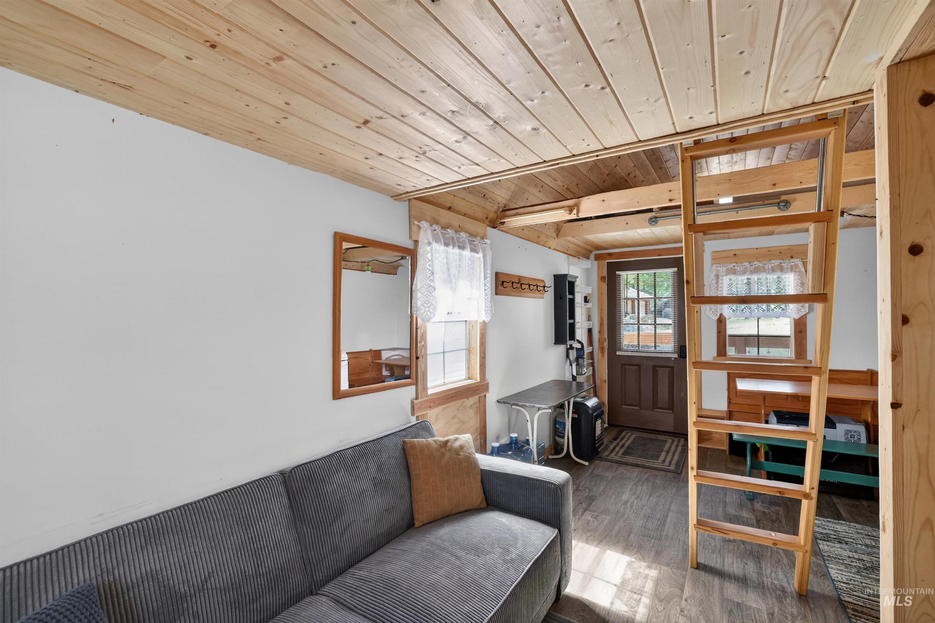 506 Hilltop Road Cascade, ID 83611 - Photo 11 of 36 Living area with a wood ceiling with exposed beams and wood finished floors