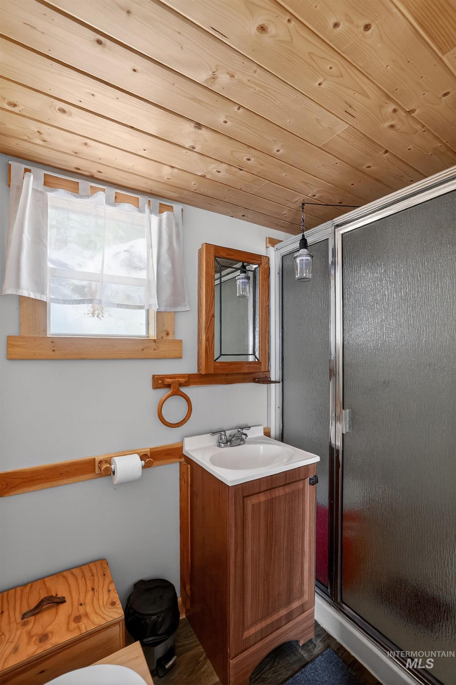 506 Hilltop Road Cascade, ID 83611 - Photo 12 of 36 Full bathroom featuring vanity, a shower stall, and wood ceiling
