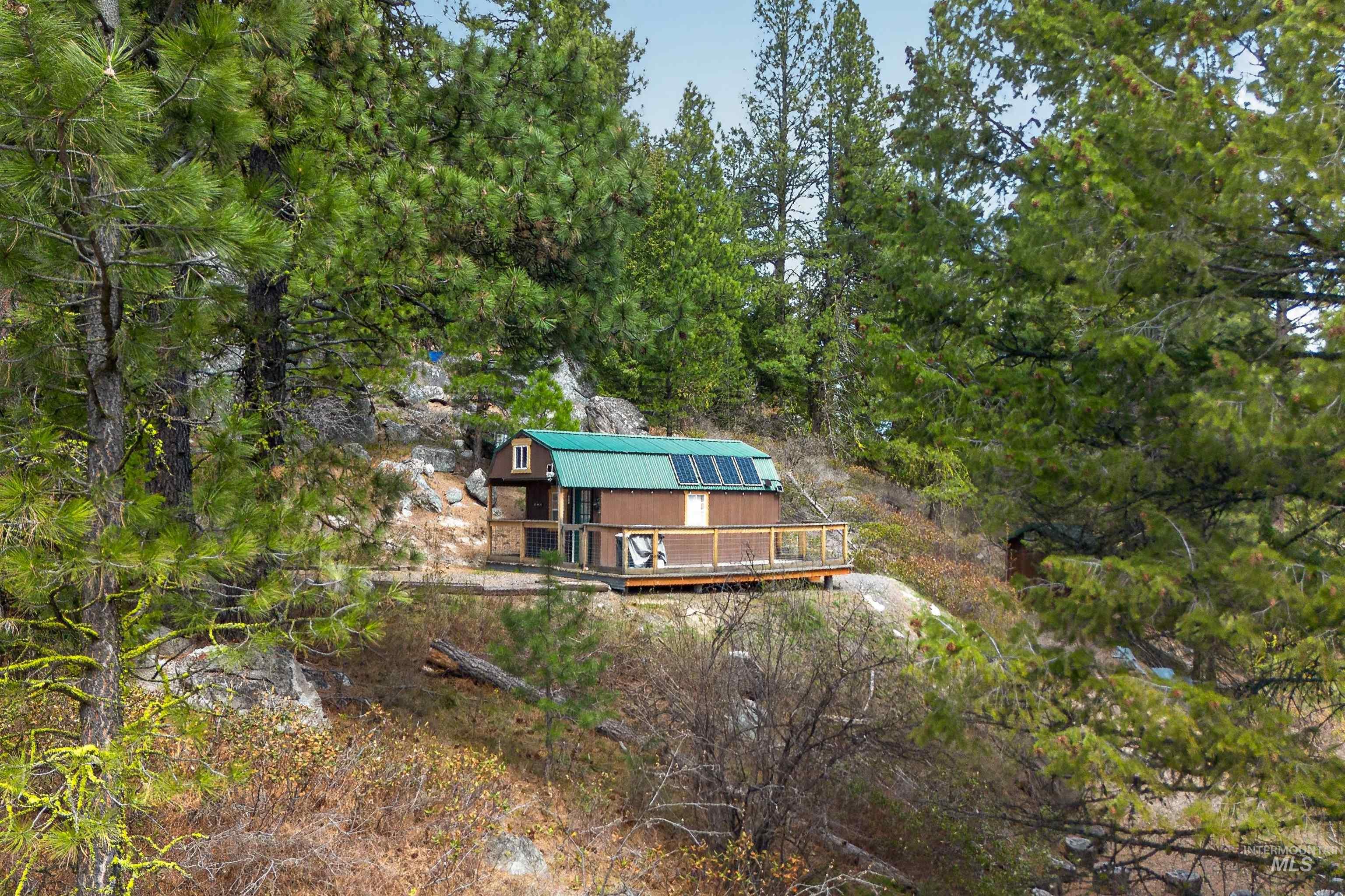 506 Hilltop Road Cascade, ID 83611 - Photo 17 of 36 Back of property with a gambrel roof and a deck