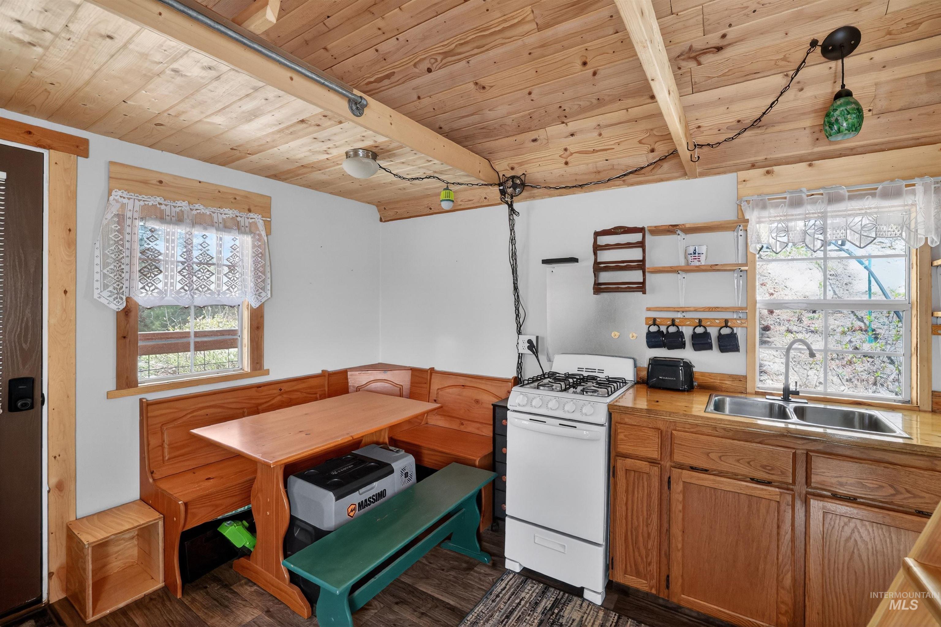 506 Hilltop Road Cascade, ID 83611 - Photo 7 of 36 Kitchen with wood ceiling, white range with gas cooktop, wood finish cabinetry, open shelves, and dark wood-style floors