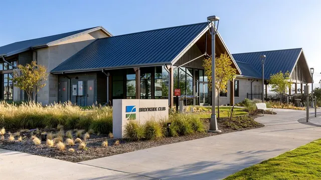 a living room with couches a large dining table and chairs with wooden floor