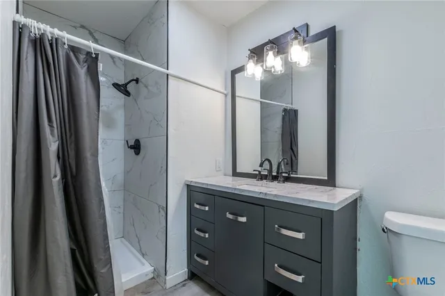 a bathroom with a shower and a sink