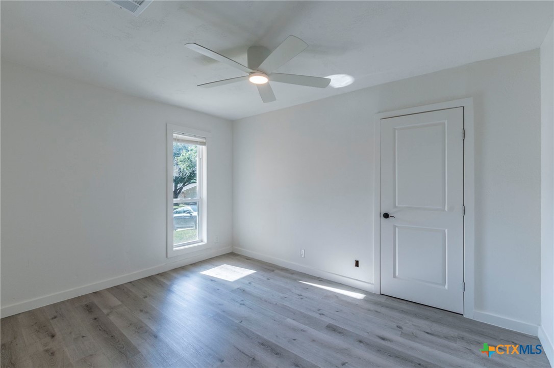 4013 Valley View Drive Temple, TX 76502 - Photo 15 of 25 a view of an empty room with wooden floor and a window