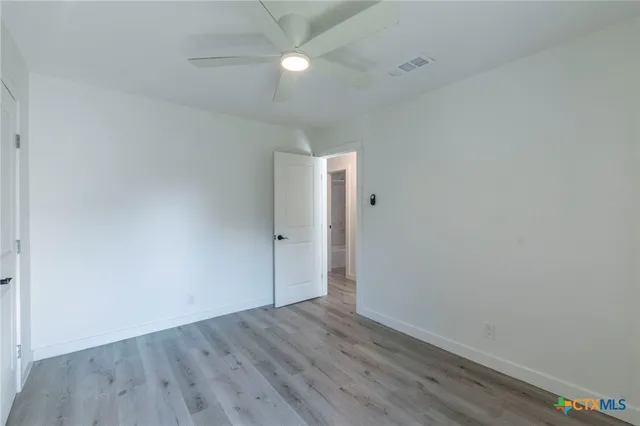 a bathroom with a granite countertop toilet a sink and mirror