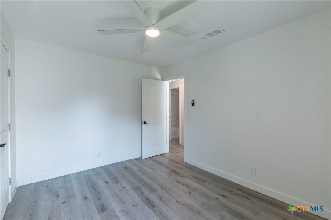 4013 Valley View Drive Temple, TX 76502 - Photo 16 of 25 a view of an empty room with wooden floor