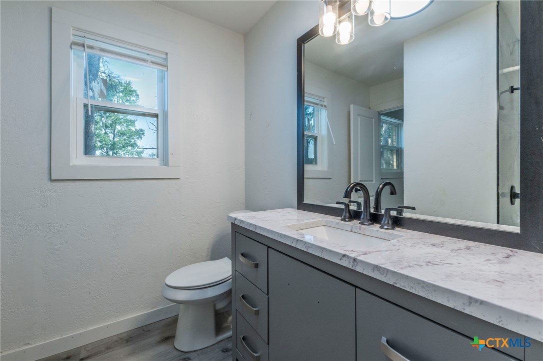 4013 Valley View Drive Temple, TX 76502 - Photo 17 of 25 a bathroom with a granite countertop toilet a sink and mirror