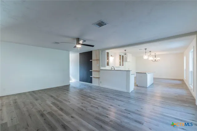 a view of a kitchen with wooden floor and windows