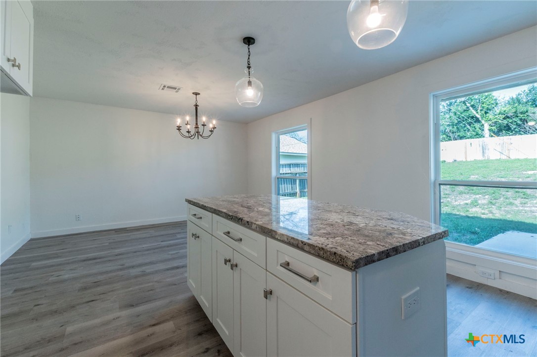 4013 Valley View Drive Temple, TX 76502 - Photo 7 of 25 a bathroom with a granite countertop sink and a window