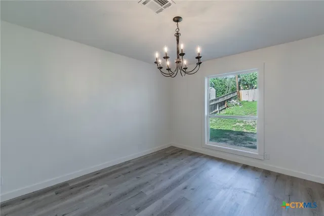a view of room with hardwood floor and window
