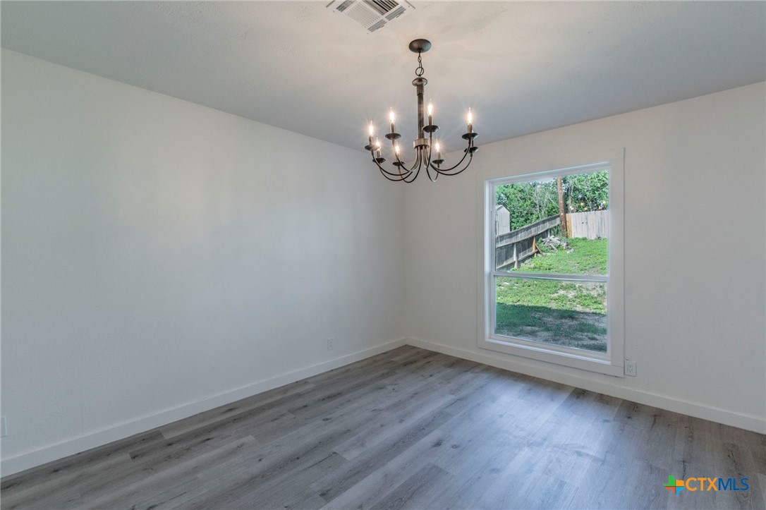 4013 Valley View Drive Temple, TX 76502 - Photo 9 of 25 a view of a room with wooden floor chandelier and window