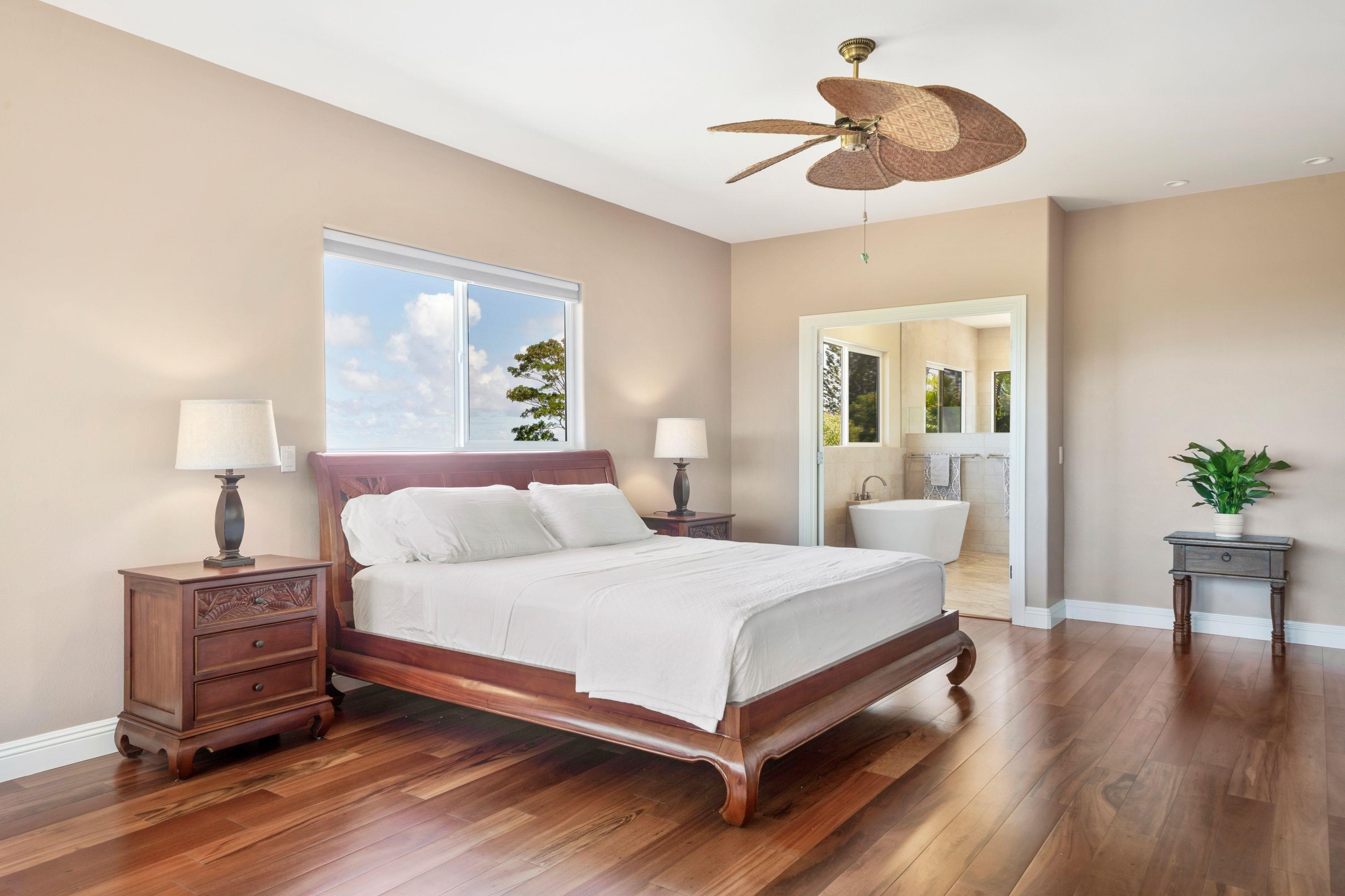500 North Holokai Place Haiku, HI 96708 - Photo 15 of 30 a bedroom with a bed chandelier and a window