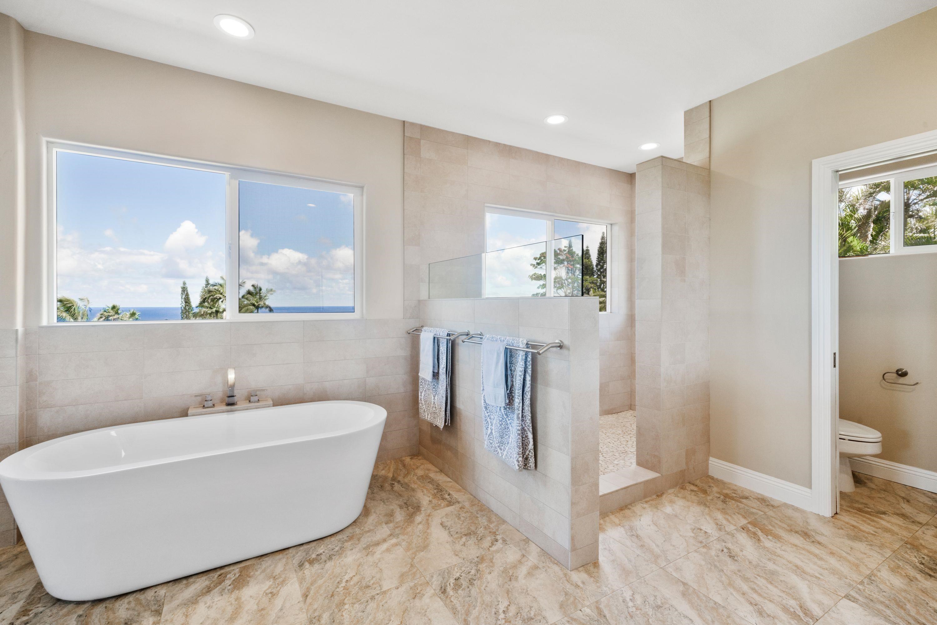 500 North Holokai Place Haiku, HI 96708 - Photo 16 of 30 a white bath tub sitting in a bathroom