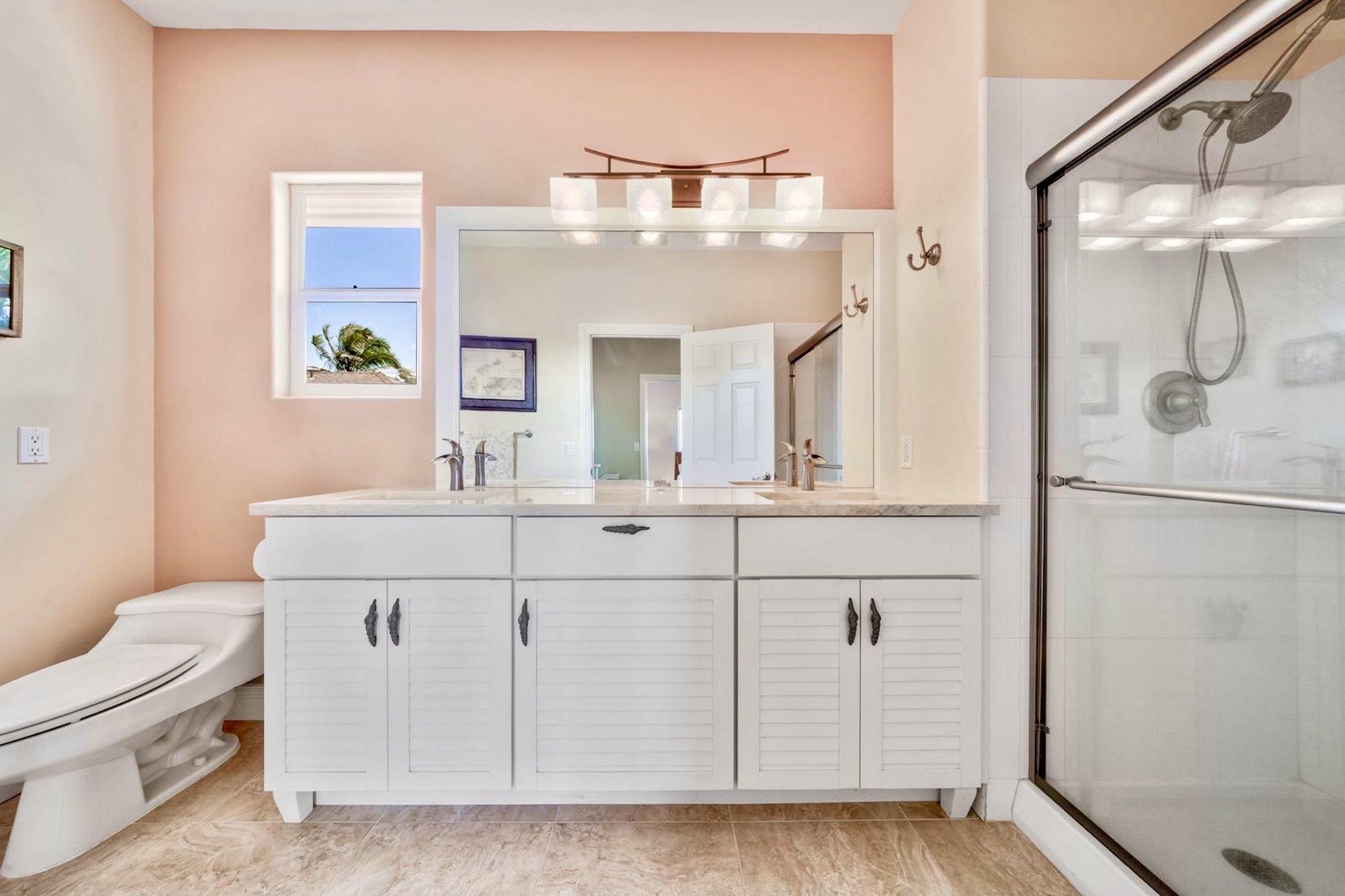 500 North Holokai Place Haiku, HI 96708 - Photo 21 of 30 a bathroom with a sink a toilet and a mirror