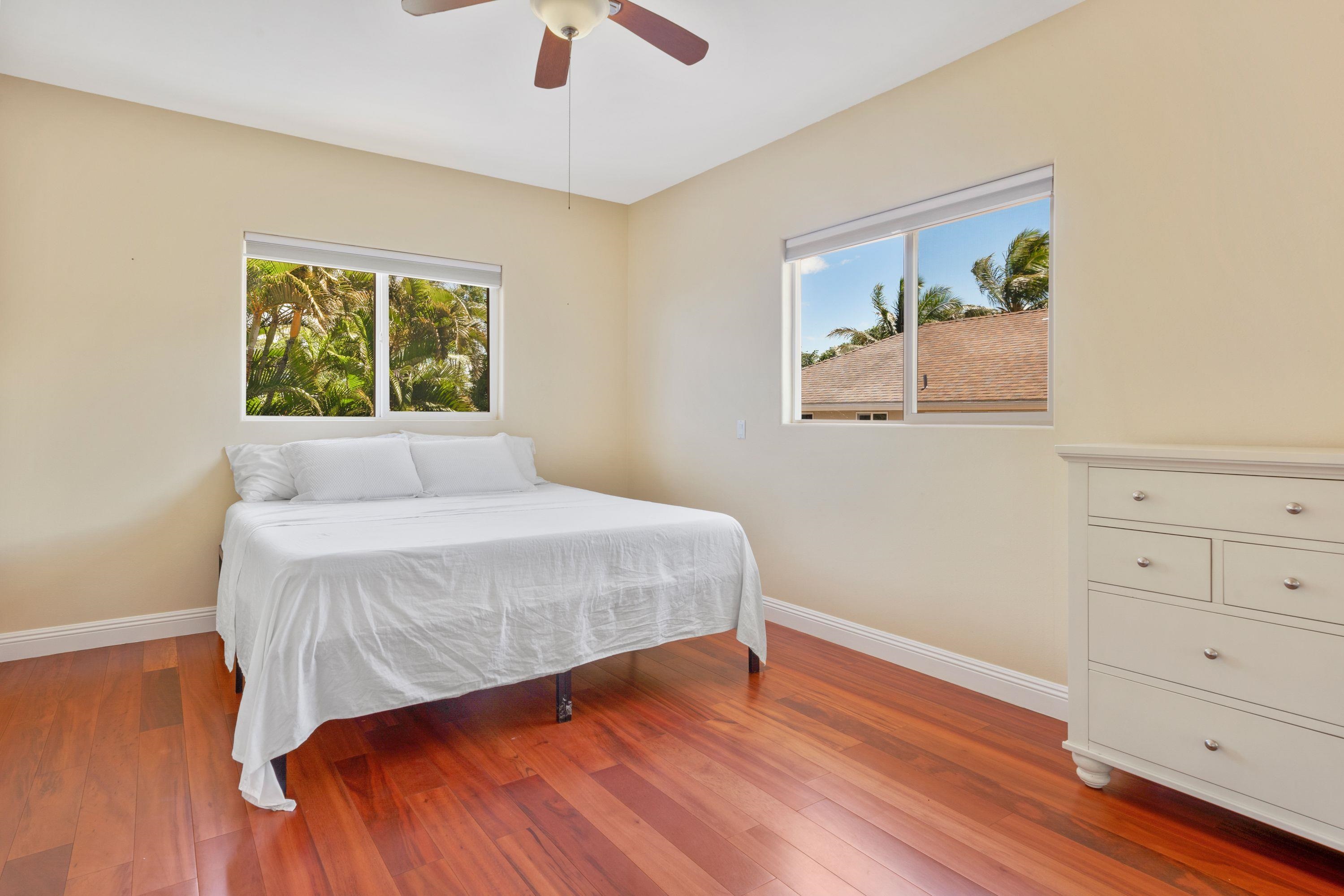 500 North Holokai Place Haiku, HI 96708 - Photo 22 of 30 a bedroom with a bed and a painting on the wall