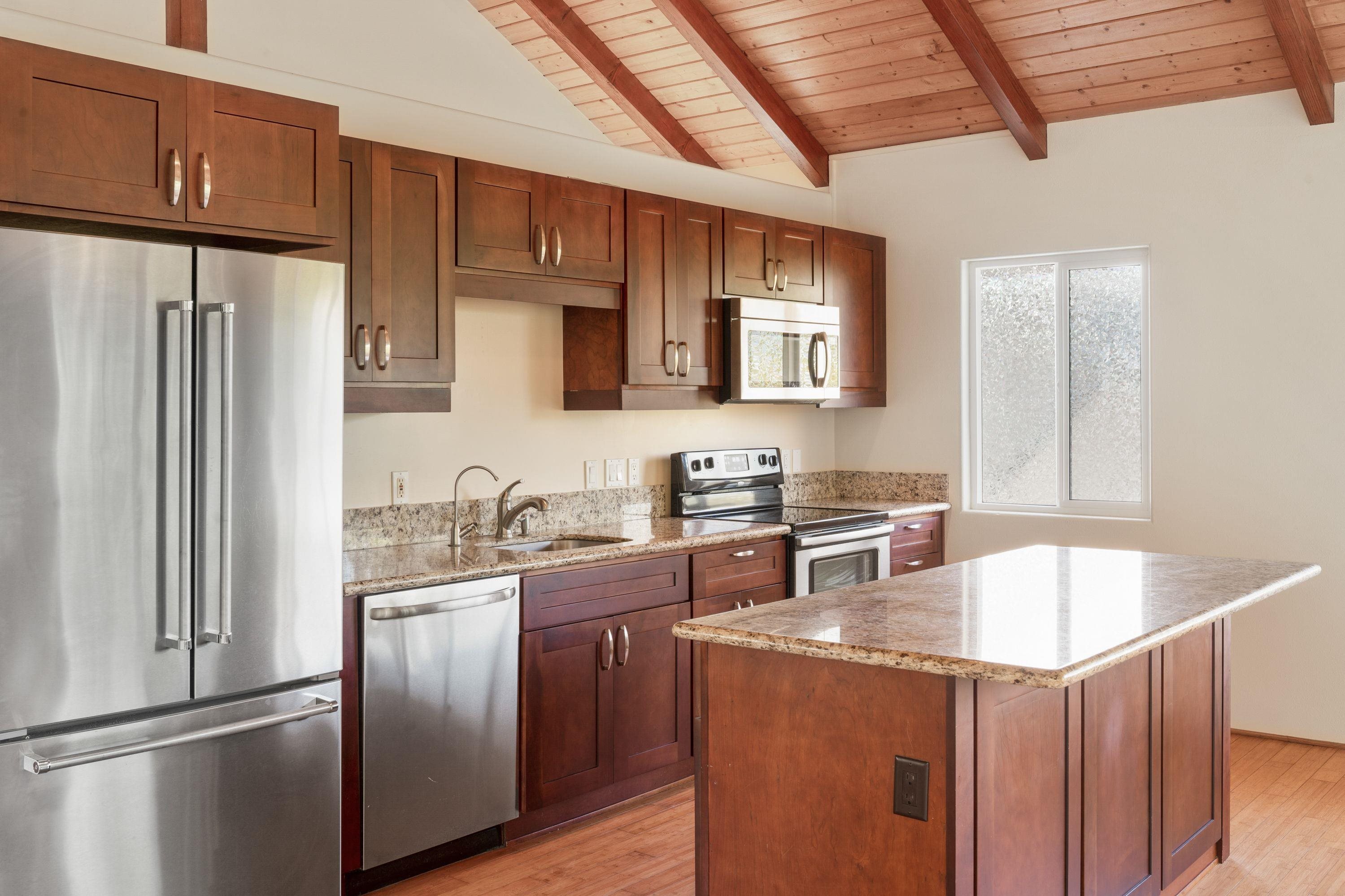 500 North Holokai Place Haiku, HI 96708 - Photo 24 of 30 a kitchen with stainless steel appliances granite countertop a refrigerator a sink and a stove