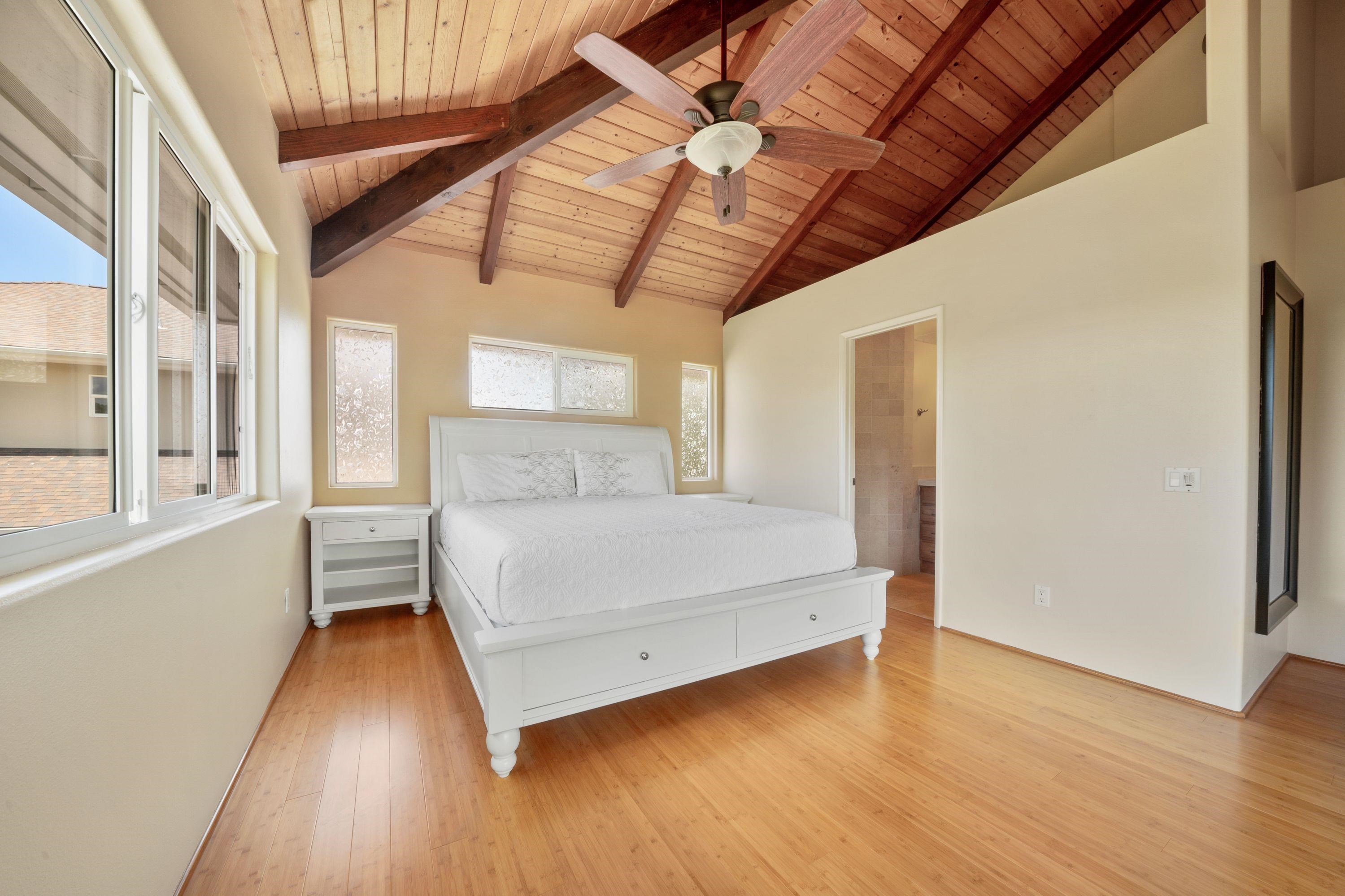 500 North Holokai Place Haiku, HI 96708 - Photo 25 of 30 a bedroom with a bed and wooden floor
