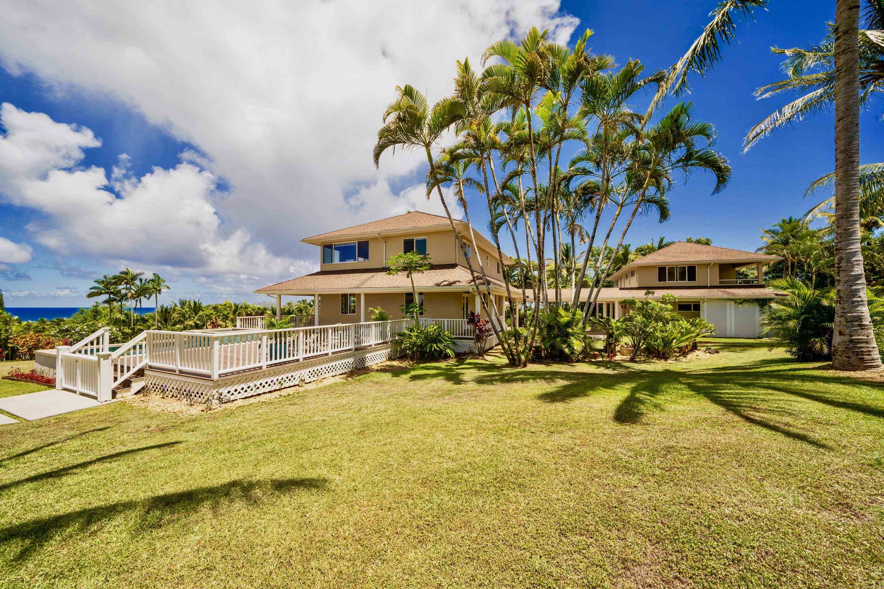 500 North Holokai Place Haiku, HI 96708 - Photo 4 of 30 a view of a swimming pool with a lawn chairs and plants