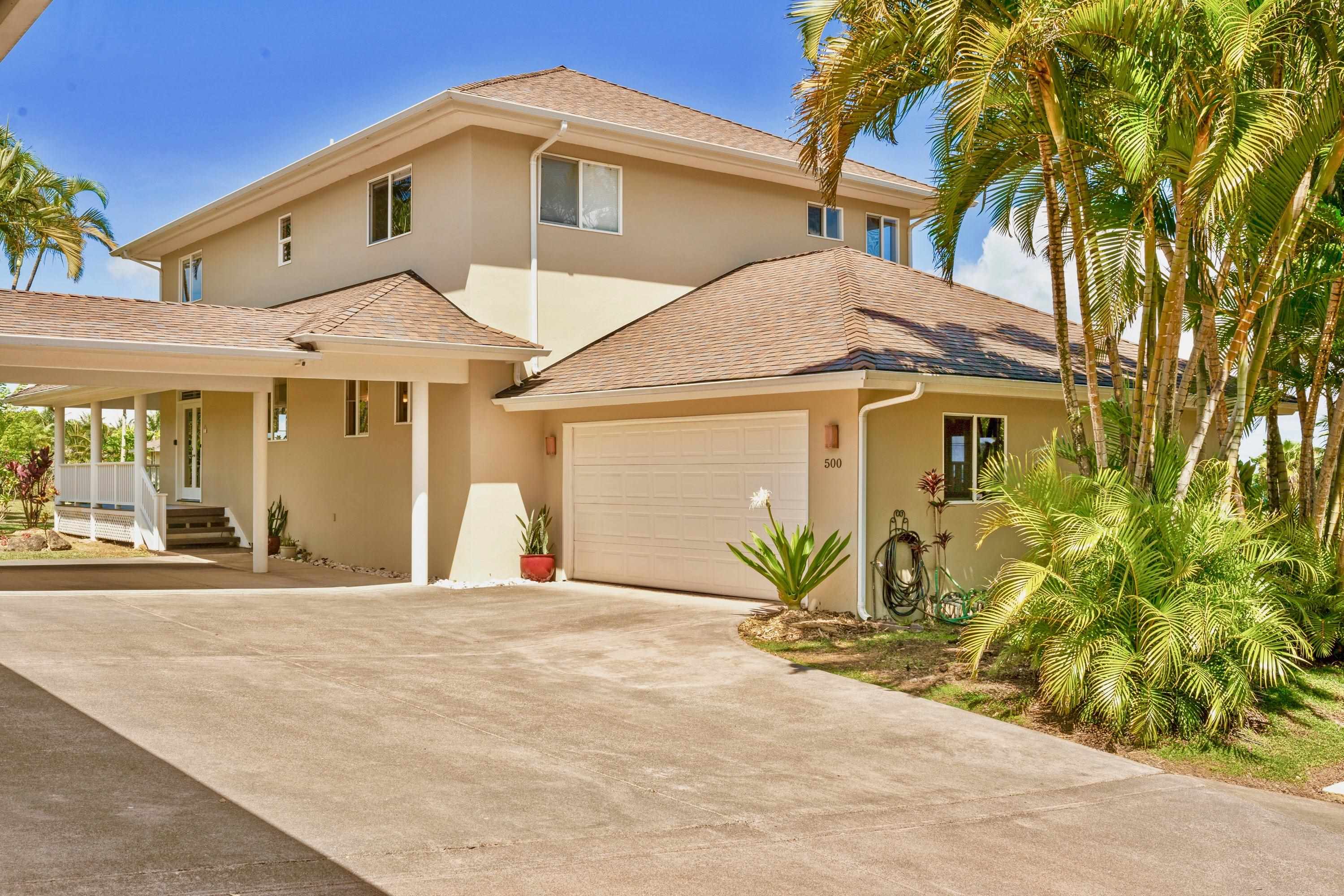500 North Holokai Place Haiku, HI 96708 - Photo 7 of 30 a front view of a house with a yard and garage