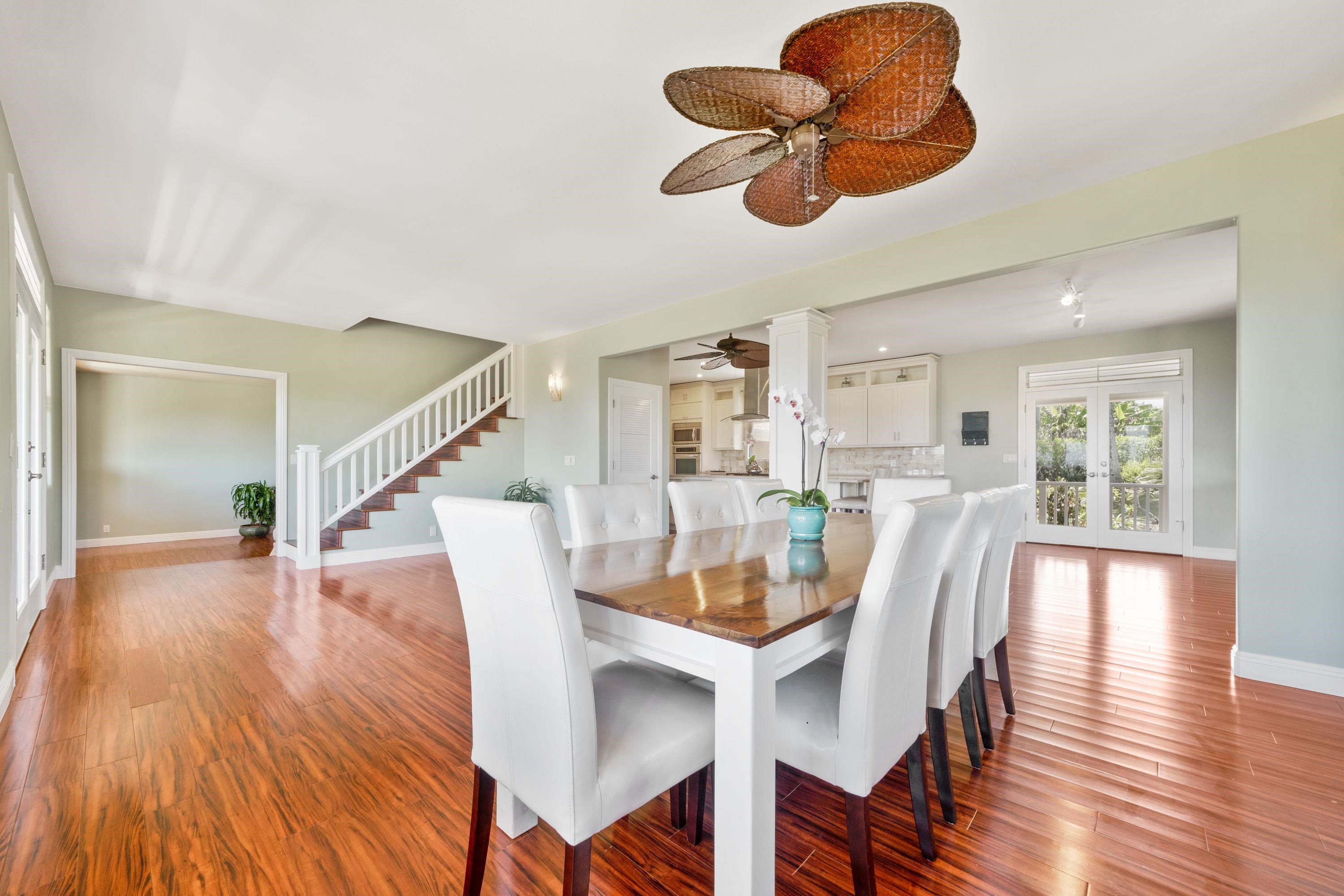 500 North Holokai Place Haiku, HI 96708 - Photo 8 of 30 a dining room with furniture a chandelier and wooden floor