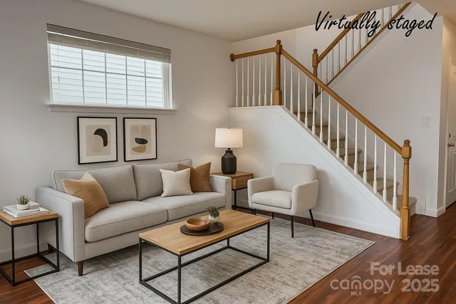 a living room with furniture wooden floor and a table
