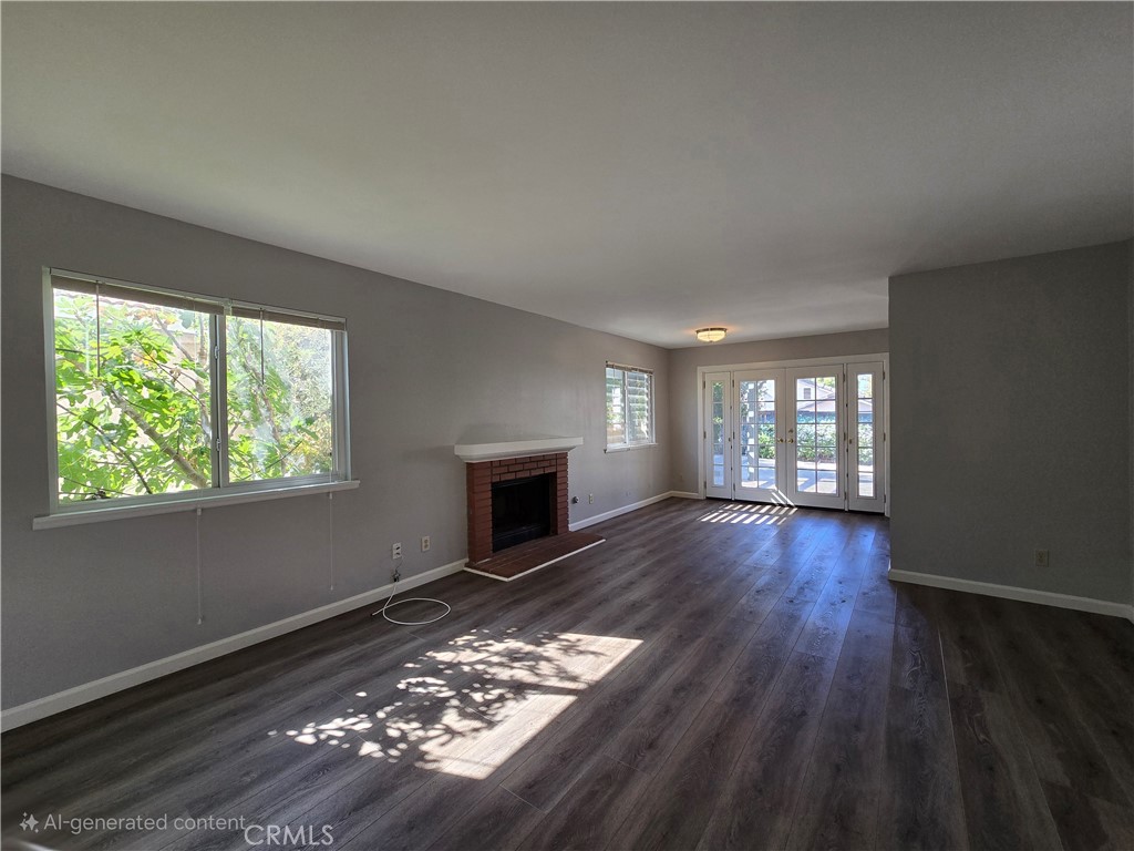 6731 Dove Lane Riverside, CA 92506 - Photo 12 of 28 a view of empty room with wooden floor and fireplace