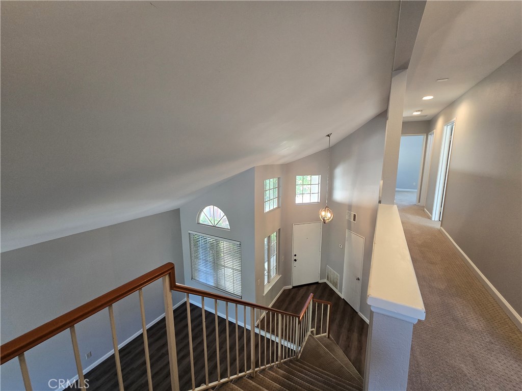 6731 Dove Lane Riverside, CA 92506 - Photo 17 of 28 a view of staircase with railing and a chandelier