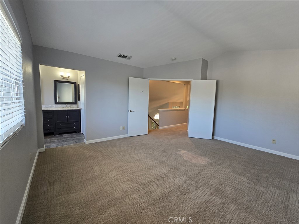 6731 Dove Lane Riverside, CA 92506 - Photo 19 of 28 an empty room with windows and closet