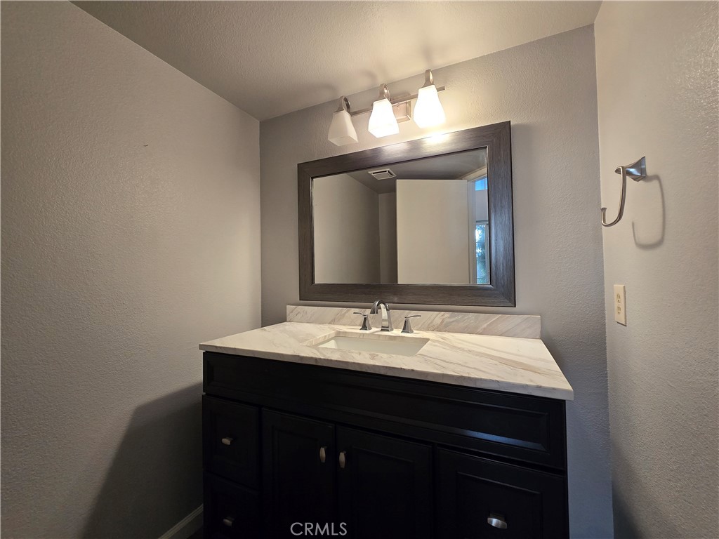 6731 Dove Lane Riverside, CA 92506 - Photo 4 of 28 a bathroom with a sink and a mirror