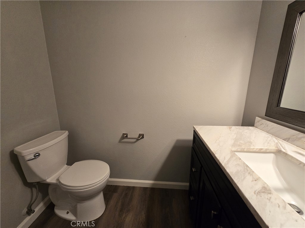 6731 Dove Lane Riverside, CA 92506 - Photo 5 of 28 a bathroom with a granite countertop toilet and a sink