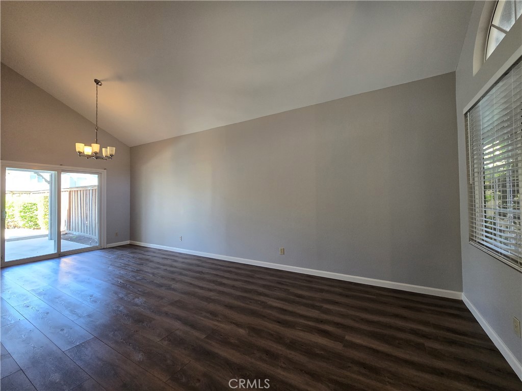 6731 Dove Lane Riverside, CA 92506 - Photo 7 of 28 an empty room with wooden floor and windows