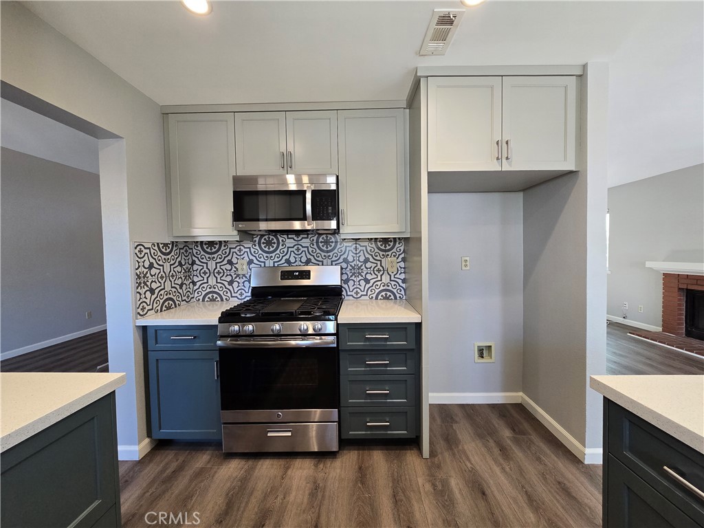 6731 Dove Lane Riverside, CA 92506 - Photo 10 of 28 a kitchen with a stove and a microwave