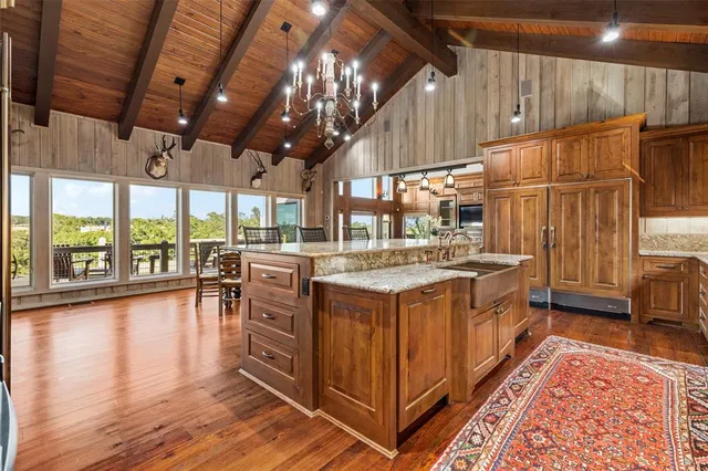 a kitchen with stove and wooden floor