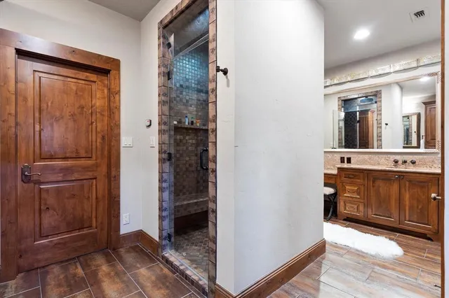 a bathroom with a sink a mirror and a shower