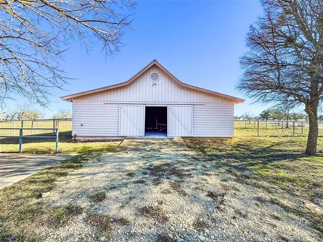 a view of a backyard with a patio and outdoor seating