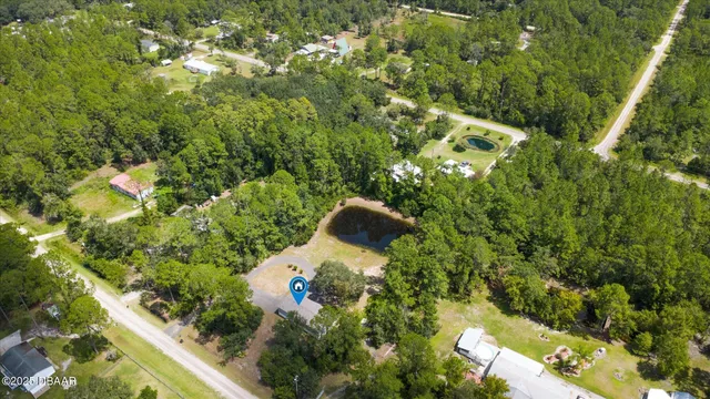 a backyard of a house with lots of green space and garden