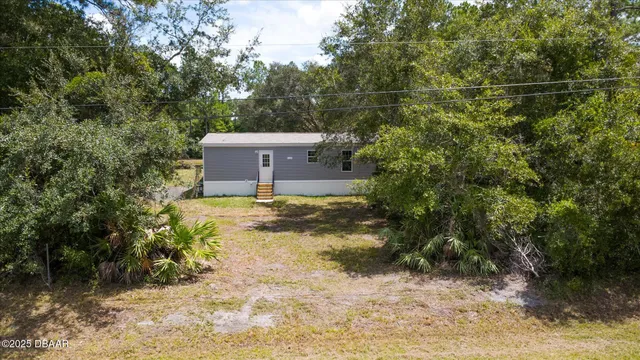 a backyard of a house with lots of green space