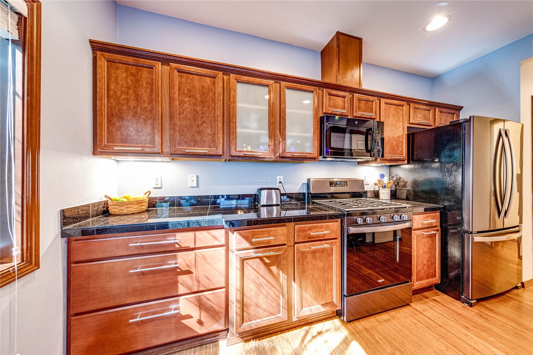 21318 11th Drive Southeast Bothell, WA 98021 - Photo 11 of 27 a kitchen with stainless steel appliances granite countertop a stove and a refrigerator
