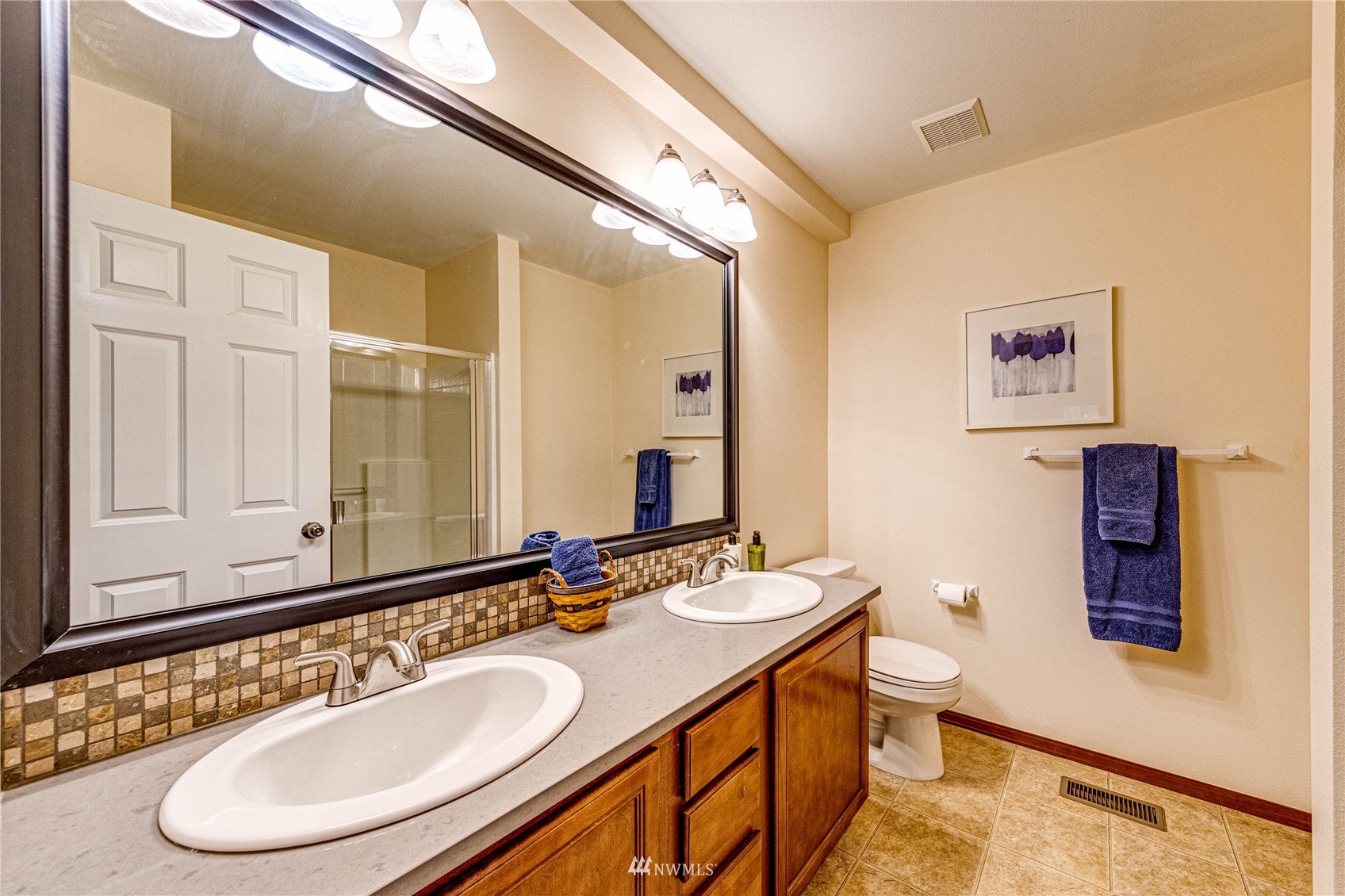 21318 11th Drive Southeast Bothell, WA 98021 - Photo 15 of 27 a bathroom with a double vanity sink and a mirror