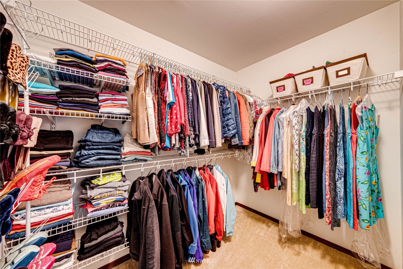 21318 11th Drive Southeast Bothell, WA 98021 - Photo 16 of 27 a view of walk in closet with clothes and shoes